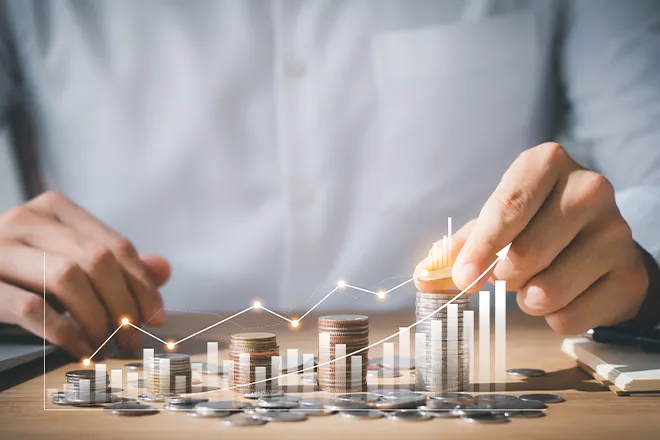 Graph and stacks of coins representing growing investments