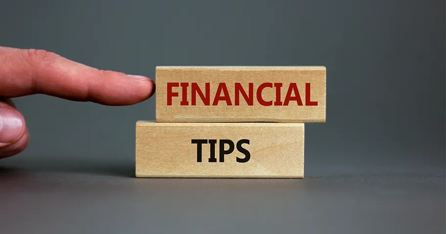 Two wooden blocks with financial tips written across them