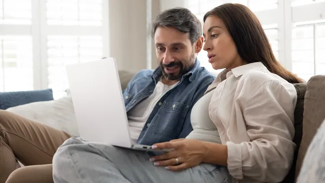 A man and woman look at a laptop and consider their redraw and offset options.