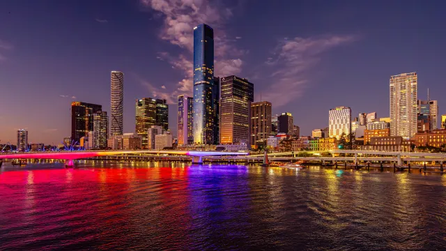 View of Brisbane city from water at sunset.