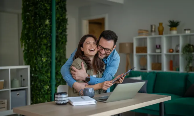 Couple looking happy after saving money.