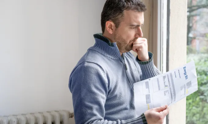 A man is concerned by his energy bill.