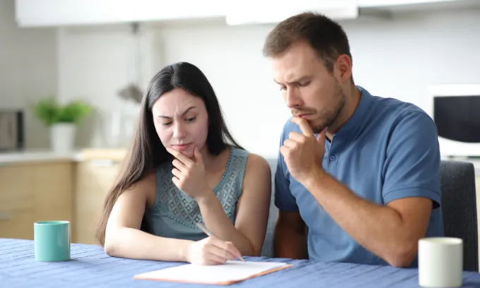 A woman thinks about adding her partner to her mortgage.