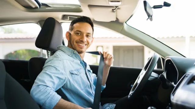 Close up of a male driver seated inside a car