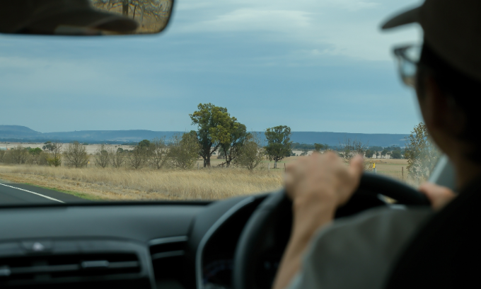 Close up of person in glasses driving.