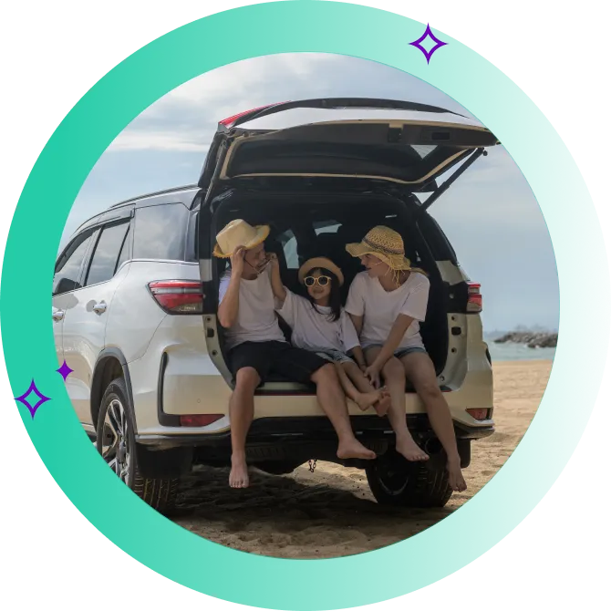 A family seated on the boot of their SUV