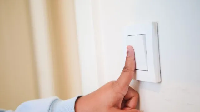 Child flipping a switch at home