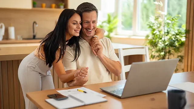 Woman and man happily enjoying the process of opening up a new transaction account