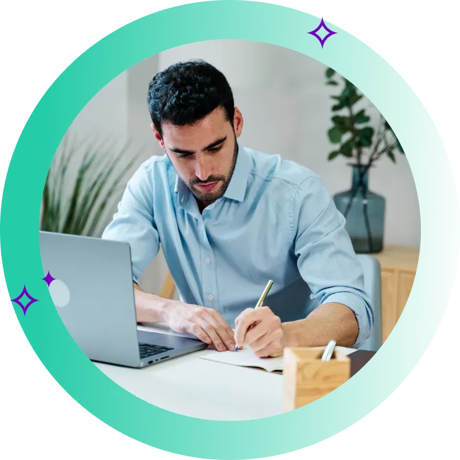 Man comparing personal loans on his laptop while taking notes