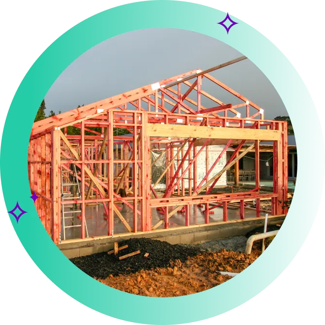 Wooden frame of new-build home on concrete slab.