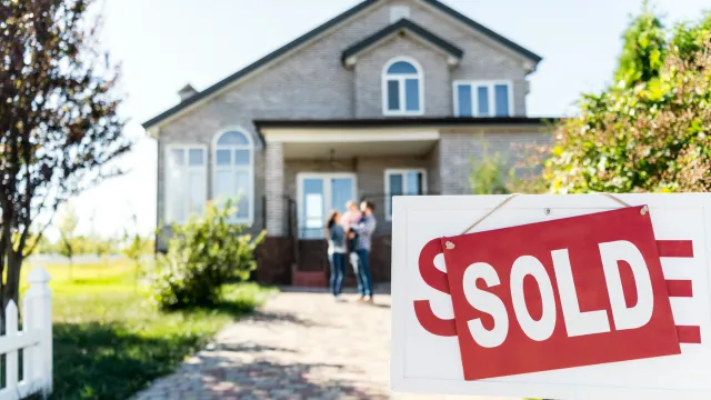 Sold house with blurred family on background