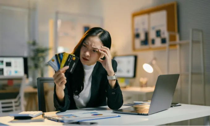 Woman looking at her credit cards.