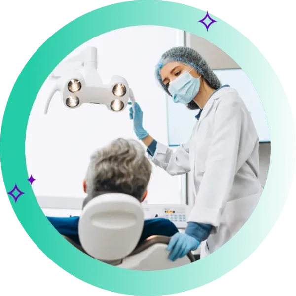 Dentist looks at patient in dentist chair