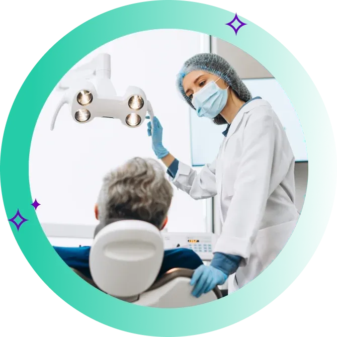 Dentist looks at patient in dentist chair