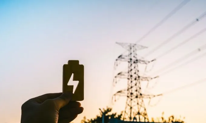 Wooden energy signs with large electric pole in the background