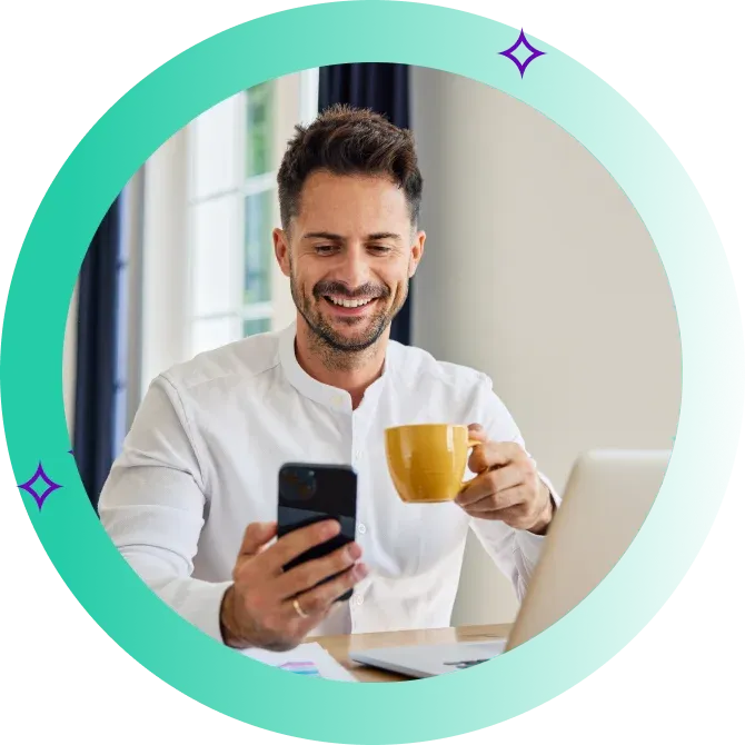 Man drinking coffee and smiling at his phone