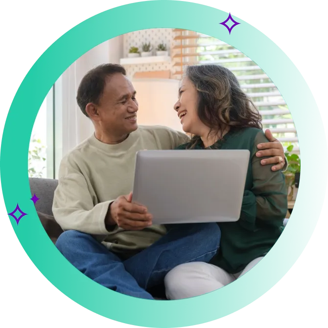An older couple looking at a laptop.