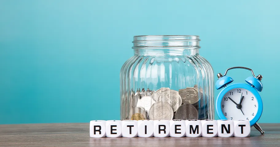 Jar of coins, a clock and blocks spelling out retirement.