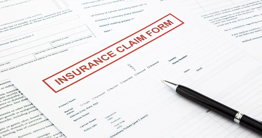 Insurance claim form and pen
