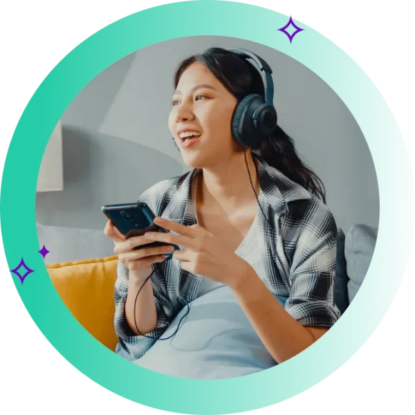 Young woman sitting on a couch, happy after switching internet providers on her phone