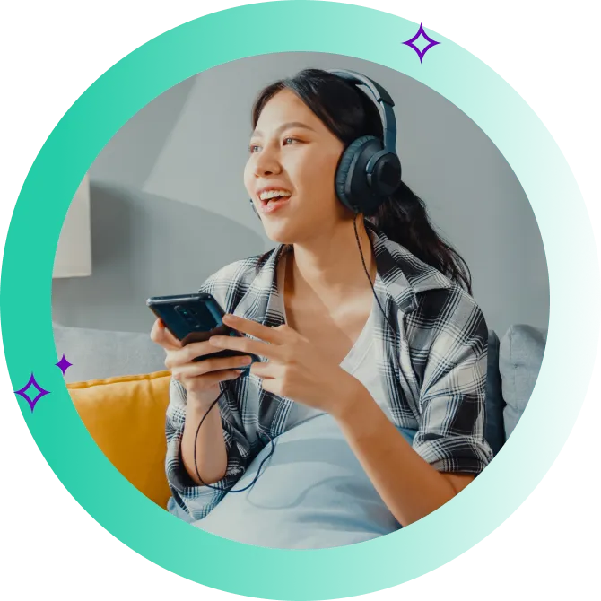 Young woman sitting on a couch, happy after switching internet providers on her phone