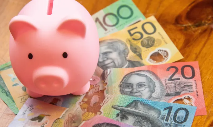 Close up on a piggy bank and Australian cash notes.