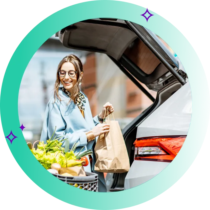 A woman storing her groceries in the boot of her car