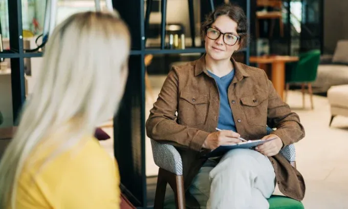 A female mental health professional discusses options for a mental health care plan with a female patient.