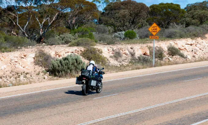 A motorcyclist on the road.