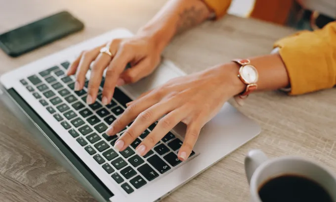 Woman searching for NBN speed explainers on her laptop