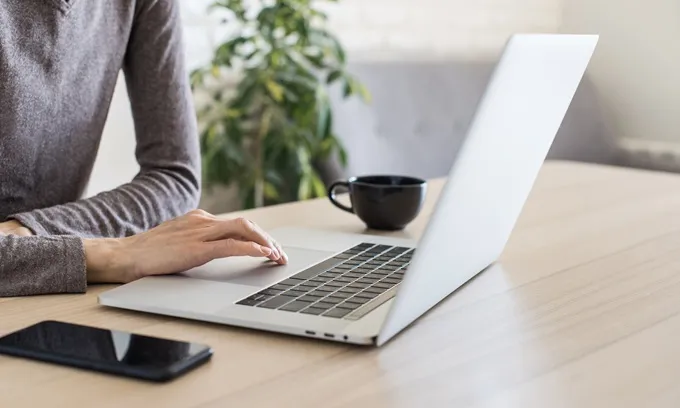 Person looking at NBN plans on laptop