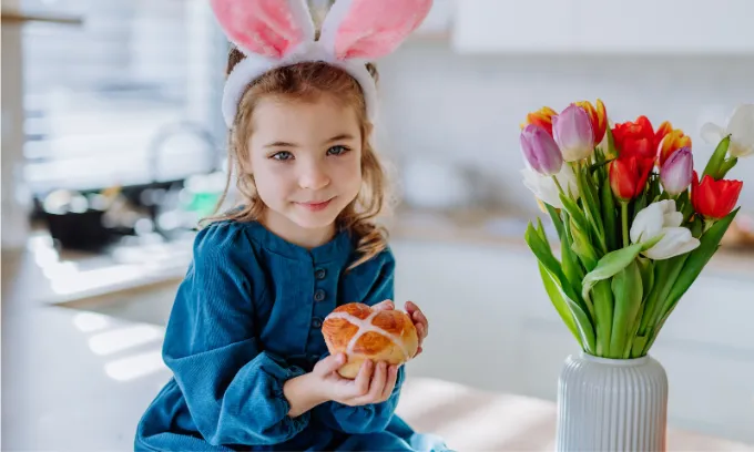 Young girl excited to try hot cross bun flavous.