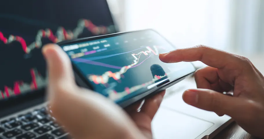 Person checking stock price graph of phone.