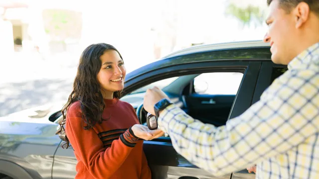 A father hands his p-plater daughter a set of car keys.
