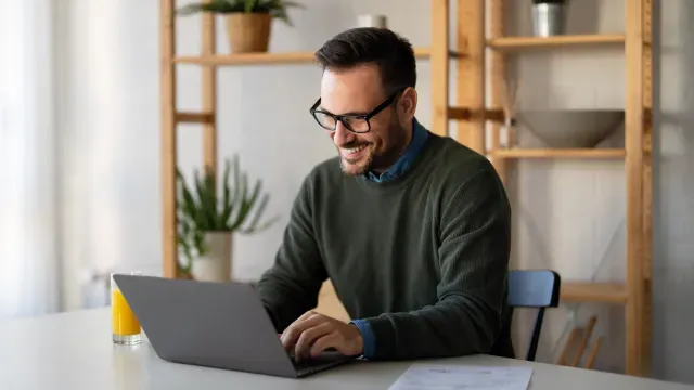 Man researching personal loans on his laptop