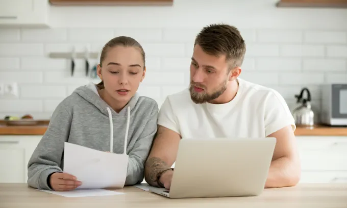 Young couple reacts to news of the June 2026 RBA cash rate decision