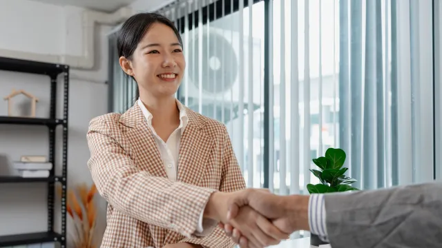 Borrower in business attire finalising a home loan with a responsible lender