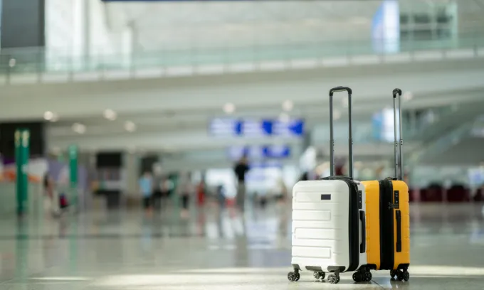 Two suitcases in an airport.