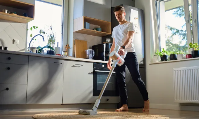 Man vacuuming.