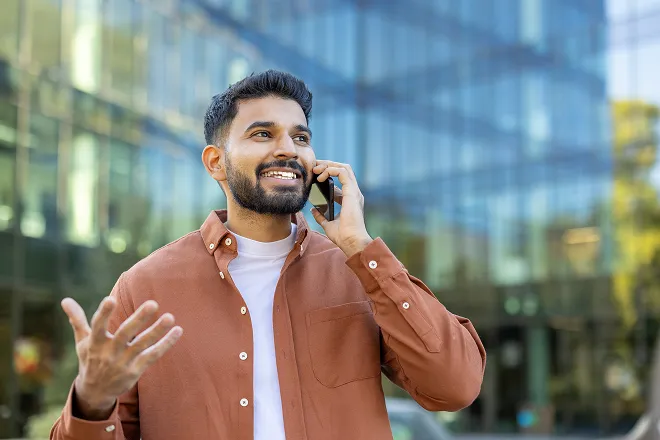 Man happily talking on the phone