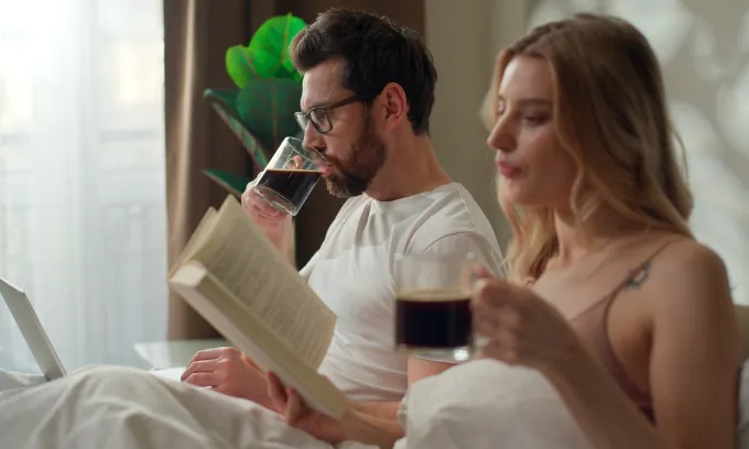 A couple spending time together in bed.