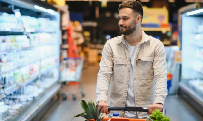 Young man doing his grocery shopping.