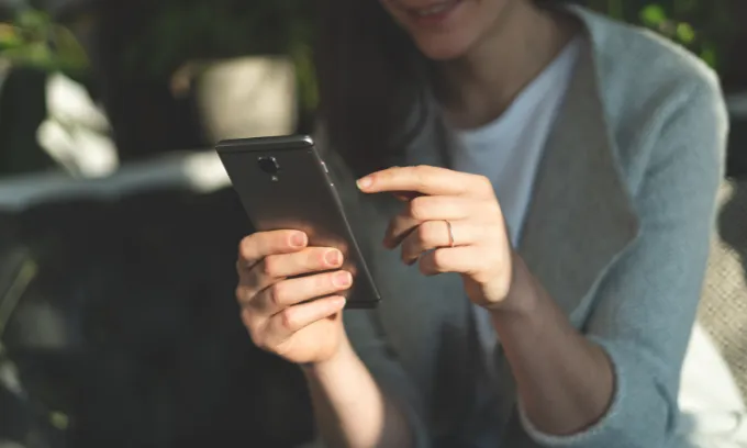 Woman looking at her internet bills on her phone