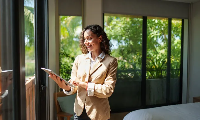 Woman looking at a tablet in her home. 