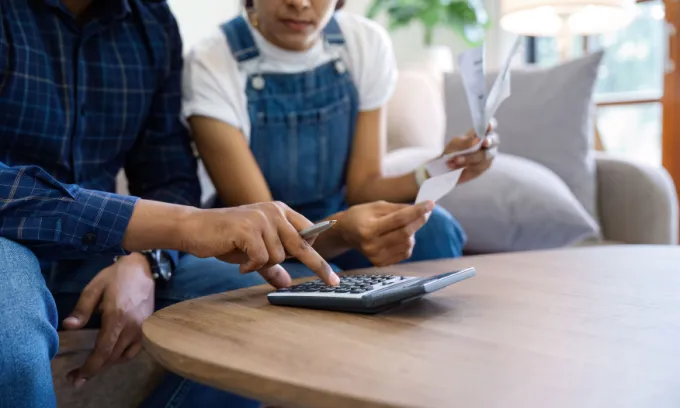 Married couple calculating home loan.