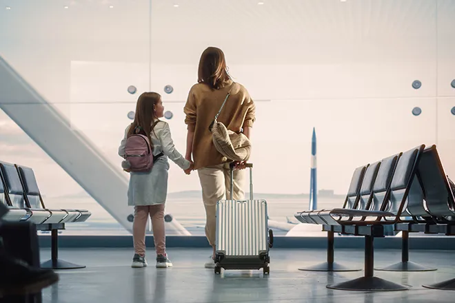 Mother and daughter in departure lounge at airport