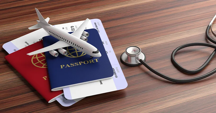 Passports with model plane and medical stethoscope