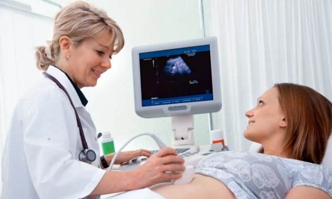 An ultrasound technician gives a pregnant woman an ultrasound