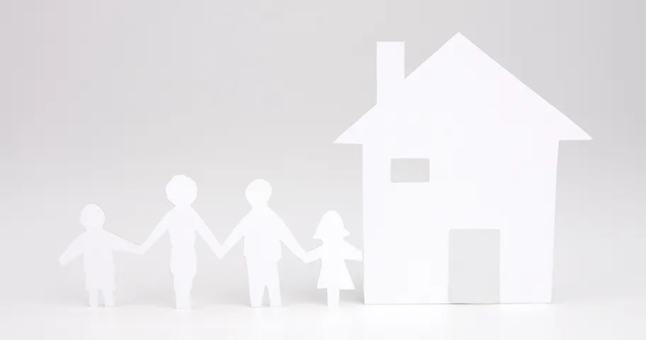 Paper cut-out of house and couple with child