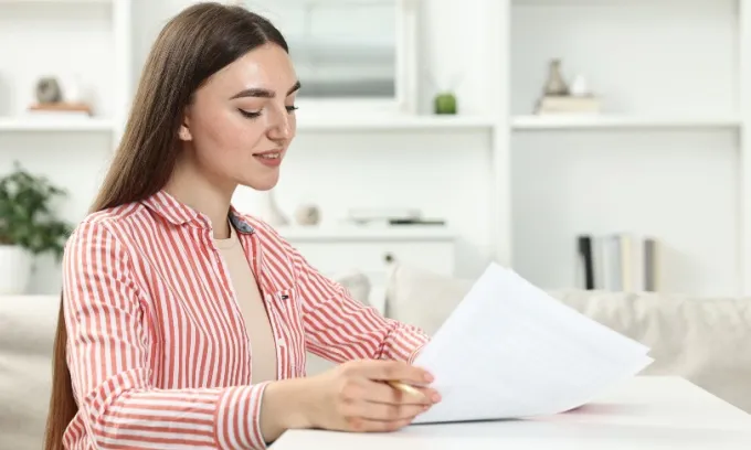 A woman looks over her health insurance policy's Private Health Information Statement.